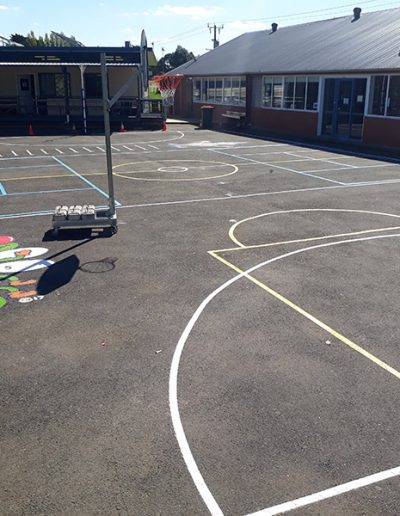 Basketball court in a school yard for students to play basketball on.