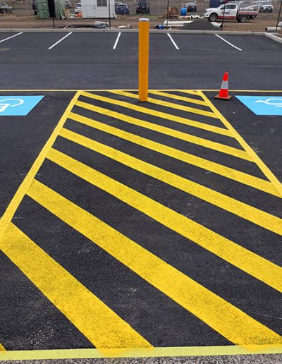 A small carpark showing a small walkway between two disabled carparks.